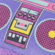 Load image into Gallery viewer, Close-up of the purple boombox from the Jackson Galaxy x Feline Frenzy Playback Duo featuring a retro design with pink speaker grilles, yellow centers, and a yellow cassette tape graphic.
