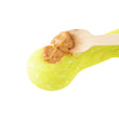 Load image into Gallery viewer, P.L.A.Y. ZoomieRex SuperZag Toy in green, close up of baby spoon with wooden handle containing peanut butter being put into one of the holes on a white background
