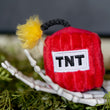 Load image into Gallery viewer, P.L.A.Y. Feline Frenzy Killer Cat Kitty-Boom Toy Set - TNT toy in hand of skeleton

