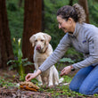 Load image into Gallery viewer, A dog in the woods with dog mom, while she places treats into top cap of the Fog City Pet x P.L.A.Y. Fun-guy toy
