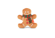Play Merry Minis Holly Jolly Gingerbread Man in warm brown fabric, wearing a red and green striped knit scarf and white embroidered facial features and icing details, photographed on a clean white background.