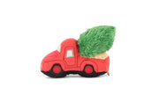 Play Merry Minis Holiday Hauler red plush toy truck with a green fuzzy Christmas tree in its bed, set against a plain white background.