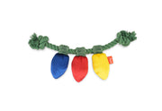 Play Merry Minis Twinkly Tugger, a dog tug toy made of green rope with three hanging plush Christmas light shapes in blue, red, and yellow, shown on a plain white background.