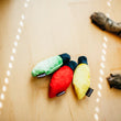 Load image into Gallery viewer, P.L.A.Y. Feline Frenzy Kitty Delights Toy Set - three ornament toys placed on wood floor with cat's paws nearby
