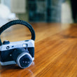 Load image into Gallery viewer, P.L.A.Y. Globetrotter Lens Licker Camera mini dog toy on a wooden surface with a blurred background
