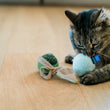 Load image into Gallery viewer, Cat playing with the Fog City Pet x Feline Frenzy Matcha Meows toy set on a wooden floor
