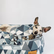 Load image into Gallery viewer, Dog laying in a Mosaic Lounge Bed in Tuxedo on a white background snuggling P.L.A.Y. Upcycled Zoo Pal Rhino plush toy inside it
