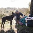 Load image into Gallery viewer, Scout &amp; About Outdoor Chill Pad in Mocha and Vanilla on hiking backpacks with human and dog in the woods
